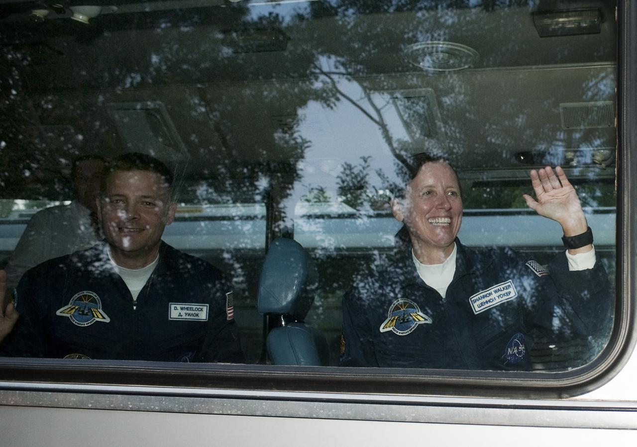 Expedition 24 NASA Flight Engineers Doug Wheelock, left, and Shannon Walker wave farewell to well-wishers as they depart the Cosmonaut Hotel on the evening before their launch on the Soyuz TMA-19 rocket to the International Space Station, Tuesday, June 15, 2010 in Baikonur, Kazakhstan.  Photo Credit: (NASA/Carla Cioffi)