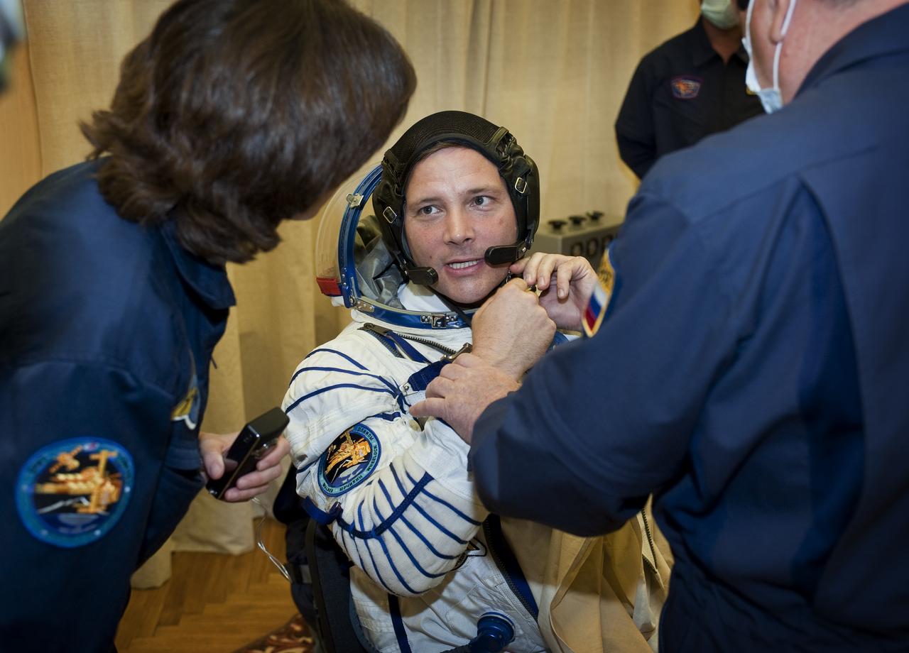 Expedition 24 NASA Flight Engineer Doug Wheelock, center, has his Russian Sokol suit prepared for launch by a technician at the Baikonur Cosmodrome in Baikonur, Kazakhstan, Tuesday, June 15, 2010. Wheelock, Soyuz Commander Fyodor Yurchikhin and Flight Engineer Shannon Walker launched in their Soyuz TMA-19 rocket from the Baikonur Cosmodrome in Kazakhstan on Wednesday, June 16, 2010. (Photo Credit: NASA/Carla Cioffi)