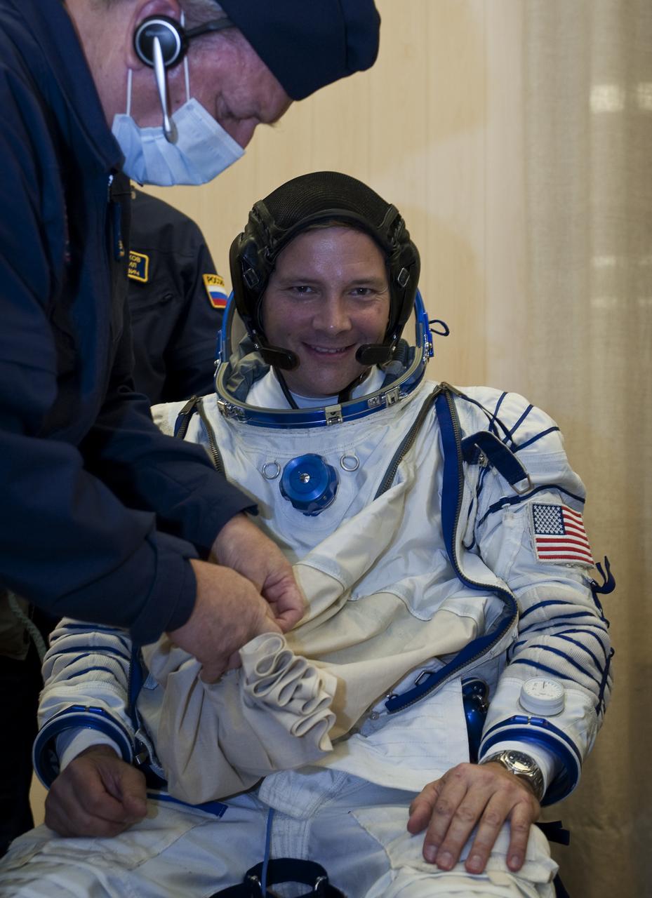 Expedition 24 NASA Flight Engineer Doug Wheelock has his Russian Sokol suit prepared for launch by a technician at the Baikonur Cosmodrome in Baikonur, Kazakhstan, Tuesday, June 15, 2010. Wheelock, Soyuz Commander Fyodor Yurchikhin and Flight Engineer Shannon Walker launched in their Soyuz TMA-19 rocket from the Baikonur Cosmodrome in Kazakhstan on Wednesday, June 16, 2010. (Photo Credit: NASA/Carla Cioffi)