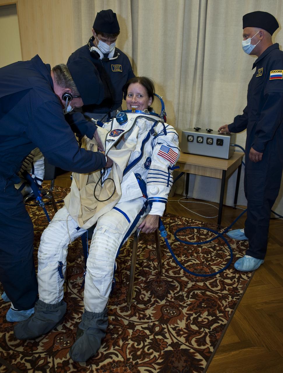 Expedition 24 NASA Flight Engineer Shannon Walker has her Russian Sokol suit prepared for launch by technicians at the Baikonur Cosmodrome in Baikonur, Kazakhstan, Tuesday, June 15, 2010. Walker, Soyuz Commander Fyodor Yurchikhin and Flight Engineer Doug Wheelock launched in their Soyuz TMA-19 rocket from the Baikonur Cosmodrome in Kazakhstan on Wednesday, June 16, 2010. (Photo Credit: NASA/Carla Cioffi)