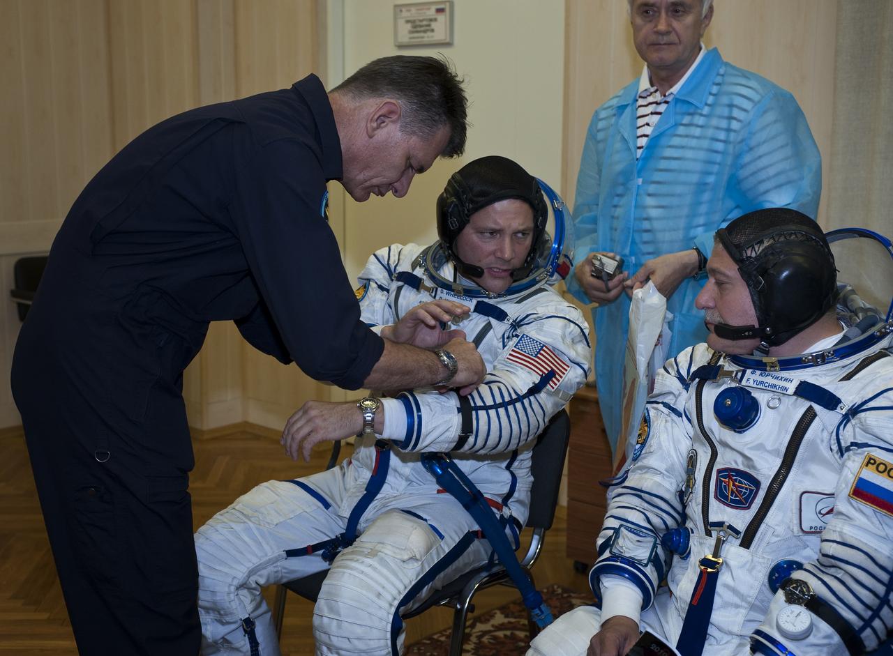 Expedition 24 back-up European Space Agency crew member Paolo Nespoli of Italy, far left, helps Doug Wheelock and Soyuz Commander Fyodor Yurchikhin with their Russian Sokol suit preparations at the Baikonur Cosmodrome in Baikonur, Kazakhstan, Tuesday, June 15, 2010. Photo Credit: (NASA/Carla Cioffi)