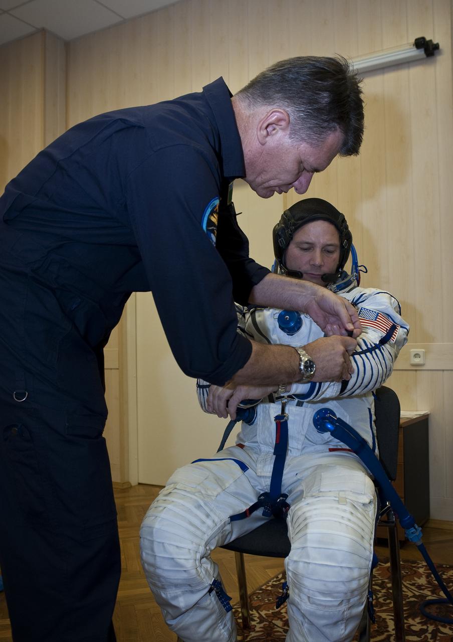 Expedition 24 back-up European Space Agency crew member Paolo Nespoli of Italy helps Doug Wheelock with his Russian Sokol suit preparations at the Baikonur Cosmodrome in Baikonur, Kazakhstan, Tuesday, June 15, 2010. Photo Credit: (NASA/Carla Cioffi)