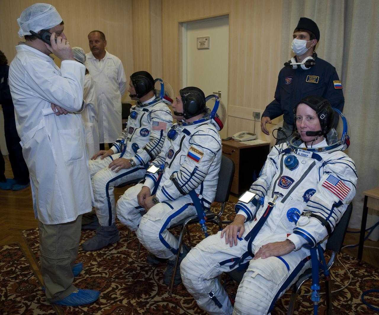 Expedition 24 NASA Flight Engineer Shannon Walker, far right, Soyuz Commander Fyodor Yurchikhin, second from right, and Flight Engineer Doug Wheelock don their Russian Sokol suits at the Baikonur Cosmodrome in Baikonur, Kazakhstan, Tuesday, June 15, 2010. Walker, Yurchikhin and Wheelock launched in their Soyuz TMA-19 rocket from the Baikonur Cosmodrome in Kazakhstan on Wednesday, June 16, 2010. (Photo Credit: NASA/Carla Cioffi)