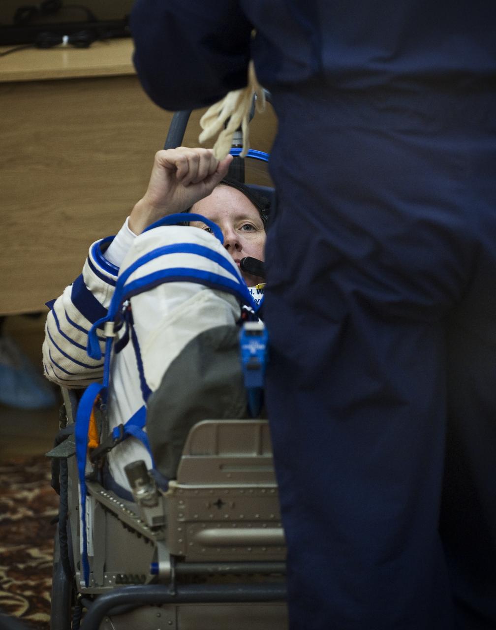 Expedition 24 Flight Engineer Shannon Walker has her Russian Sokol suit pressure checked at the Baikonur Cosmodrome in Baikonur, Kazakhstan, Tuesday, June 15, 2010. Walker and fellow Expedition 24 crew members Flight Engineers Doug Wheelock and Soyuz Commander Fyodor Yurchikhin launched in their Soyuz TMA-19 rocket from the Baikonur Cosmodrome in Kazakhstan on Wednesday, June 16, 2010 at 3:35 a.m. Kazakhstan time. (Photo Credit: NASA/Carla Cioffi)