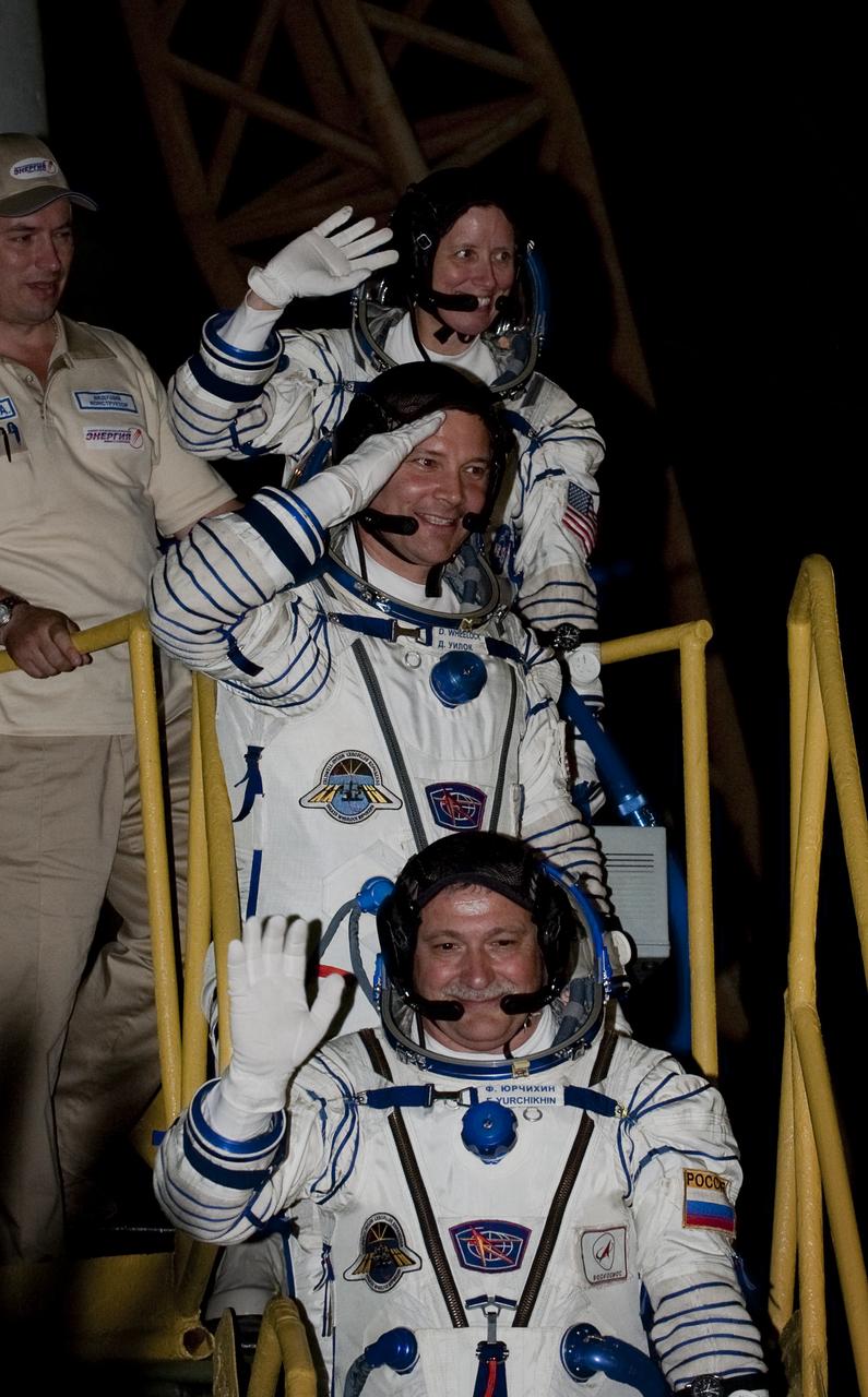 Expedition 24 NASA Flight Engineer Shannon Walker, top, Expedition 24 NASA Flight Engineer Doug Wheelock, center, and Expedition 24 Soyuz Commander Fyodor Yurchikhin wave farewell from the bottom of the Soyuz rocket at the Baikonur Cosmodrome in Baikonur, Kazakhstan, Wednesday, June 16, 2010. Walker, Wheelock and Yurchikhin launched in their Soyuz TMA-19 rocket from the Baikonur Cosmodrome in Kazakhstan on Wednesday, June 16, 2010 at 3:35 a.m.   Photo Credit: (NASA/Carla Cioffi) 