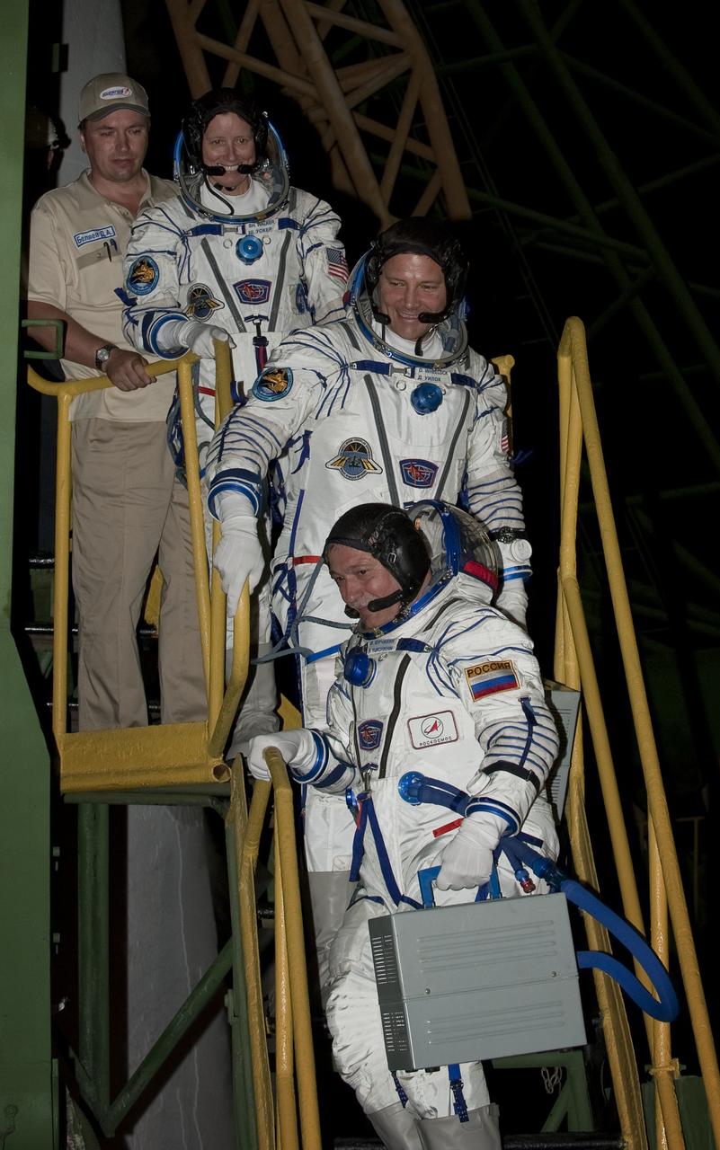 Expedition 24 NASA Flight Engineer Shannon Walker, top, Expedition 24 NASA Flight Engineer Doug Wheelock, center, and Expedition 24 Soyuz Commander Fyodor Yurchikhin prepare to board their Soyuz TMA-19 spacecraft at the Baikonur Cosmodrome in Baikonur, Kazakhstan, Wednesday, June 16, 2010. Walker, Wheelock and Yurchikhin launched in their Soyuz TMA-19 rocket from the Baikonur Cosmodrome in Kazakhstan on Wednesday, June 16, 2010 at 3:35 a.m.   Photo Credit: (NASA/Carla Cioffi)