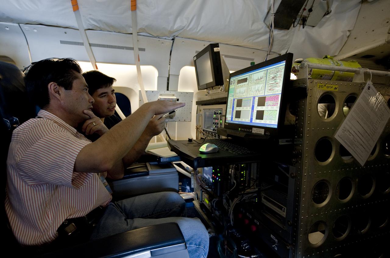 Jeffrey Beyon, left, and Paul Joseph Petzar, right, from NASA's Langley Research Center, work with DAWN Air Data  Acquisition and Processing software aboard NASA's DC-8 research aircraft, Sunday, Aug. 15, 2010, in support of the GRIP experiment at Fort Lauderdale International Airport in Fort Lauderdale, Fla.  The Genesis and Rapid Intensification Processes (GRIP) experiment is a NASA Earth science field experiment in 2010 that is being conducted to better understand how tropical storms form and develop into major hurricanes. Photo Credit: (NASA/Paul E. Alers)