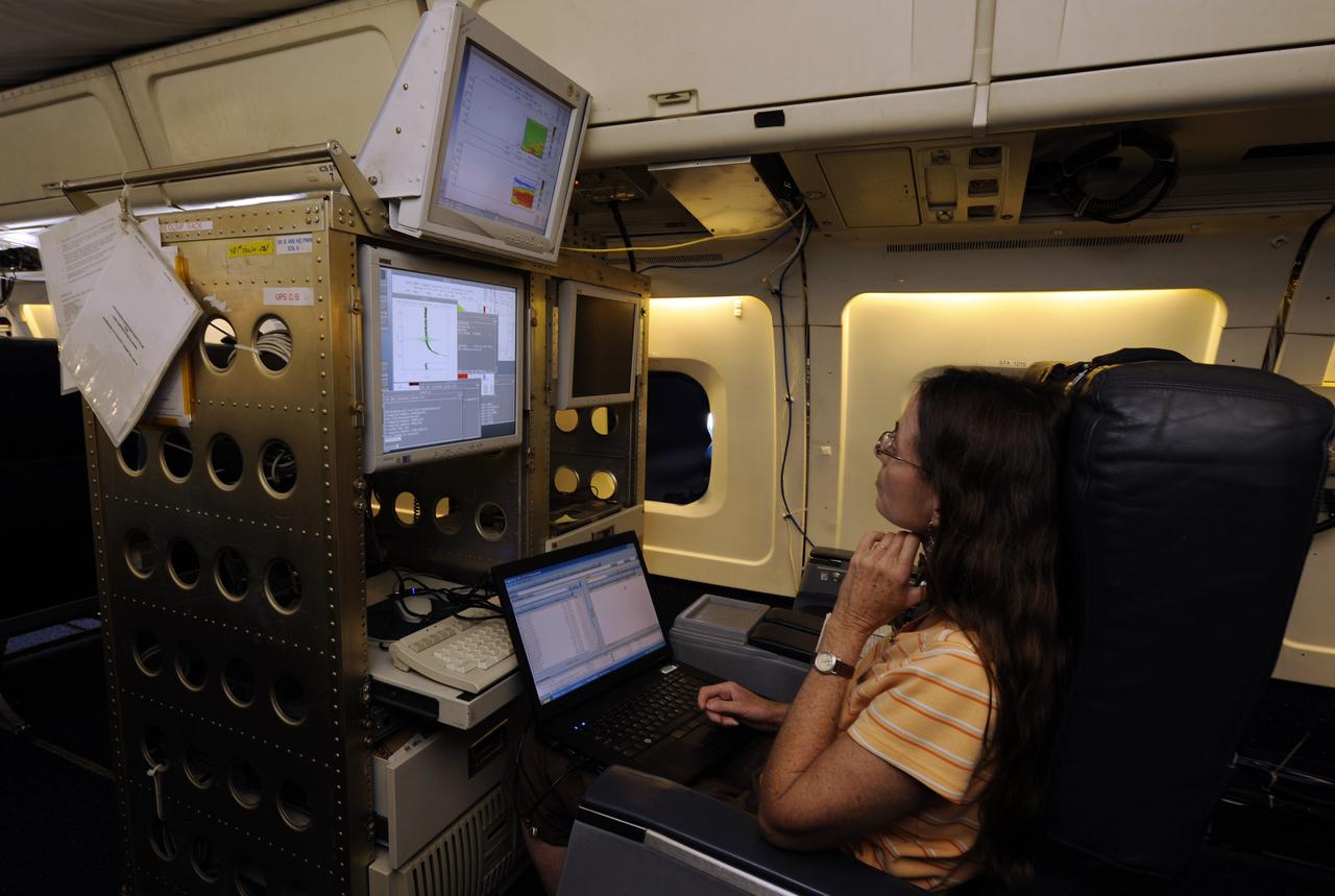 Susan Kool, a researcher from the Langley Research Center, works on monitoring the Lidar Atmospheric Sensing Experiment (LASE) aboard the NASA DC-8 aircraft, Monday, Aug. 16, 2010, at Fort Lauderdale Hollywood International Airport in Fort Lauderdale, Fla. LASE probes the atmosphere using lasers and is part of the Genesis and Rapid Intensification Processes (GRIP) experiment is a NASA Earth science field experiment in 2010 that is being conducted to better understand how tropical storms form and develop into major hurricanes. Photo Credit: (NASA/Paul E. Alers)