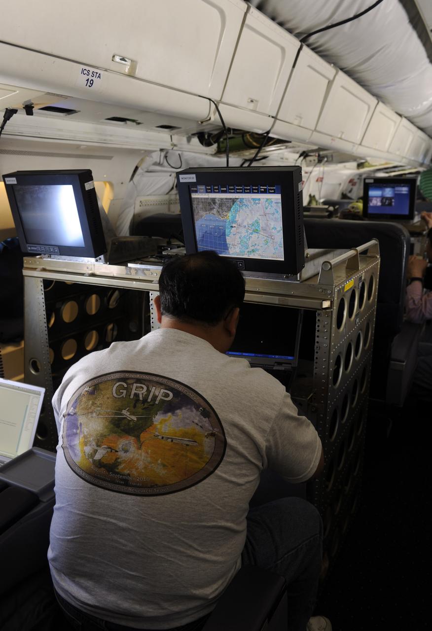 A researcher with the Genesis and Rapid Intensification Processes (GRIP) experiment works aboard the NASA DC-8 during a flight over the Gulf of Mexico, Tuesday, Aug. 17, 2010. GRIP is a NASA Earth science field experiment in 2010 that is being conducted to better understand how tropical storms form and develop into major hurricanes. Photo Credit: (NASA/Paul E. Alers)