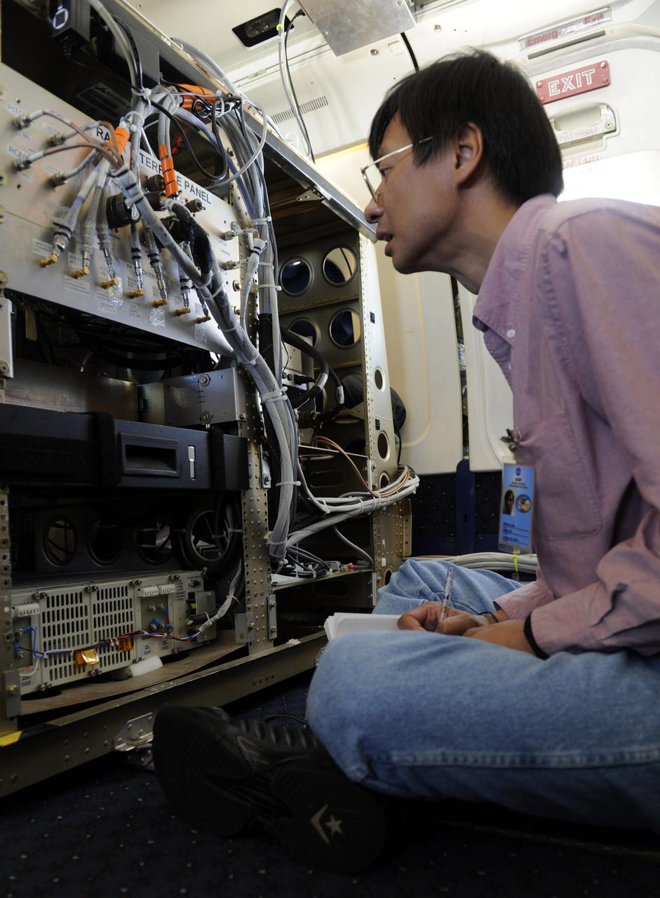An unidentified researcher looks over the wiring connecting the  Airbrorne Precipitation Radar (APR-2) during a flight aboard the NASA DC-8 aircraft,  Tuesday, Aug. 17, 2010, over the Gulf of Mexico. Scientists taking part in the Genesis and Rapid Intensification Processes (GRIP) experiment, a NASA Earth science field experiment in 2010 that is being conducted to better understand how tropical storms form and develop into major hurricanes, flew out over a weather pattern Tuesday to begin their research. Photo Credit: (NASA/Paul E. Alers)