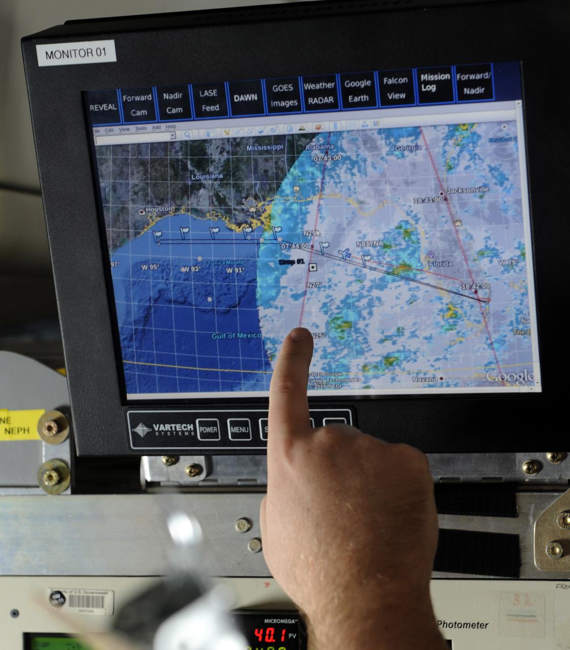 A researcher points out the trajectory of a weather pattern on a computer monitor during a flight aboard the NASA DC-8 aircraft, Tuesday, Aug. 17, 2010, over the Gulf of Mexico. Sceintists and researchers flew Tuesday to study weather as part of the Genesis and Rapid Intensification Processes (GRIP) experiment is a NASA Earth science field experiment in 2010 that is being conducted to better understand how tropical storms form and develop into major hurricanes. Photo Credit: (NASA/Paul E. Alers)