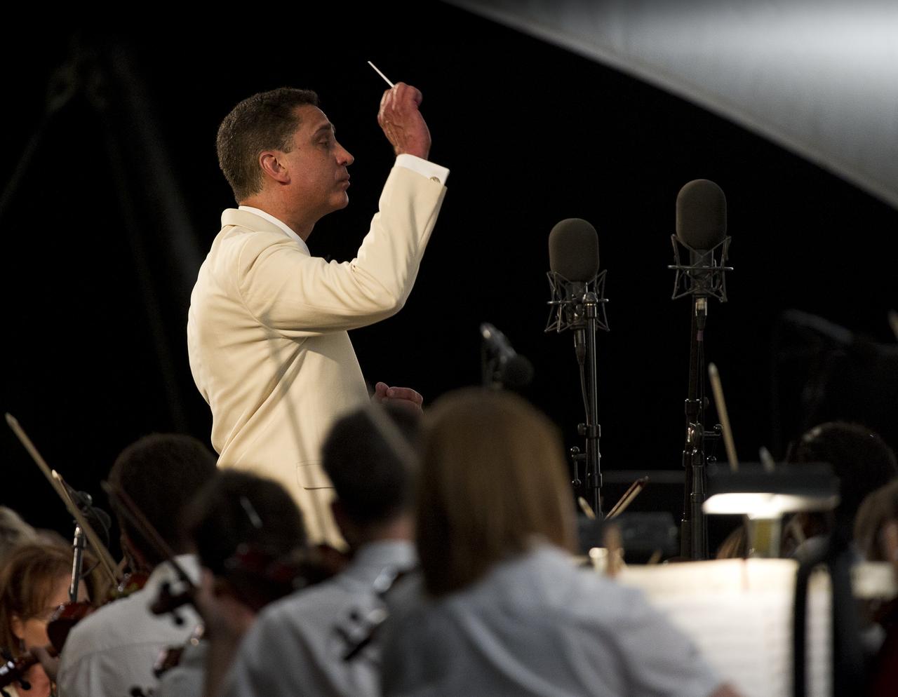 National Symphony Orchestra Conductor Emil de Cou leads the National Symphony Orchestra during the Labor Day Weekend concert on the West Lawn of the U.S. Capitol, Sunday, September 5, 2010 in Washington. NASA Administrator Charles Bolden joined the Orchestra to introduce one the program's segments, music from the film "Apollo 13". Photo Credit: (NASA/Bill Ingalls)