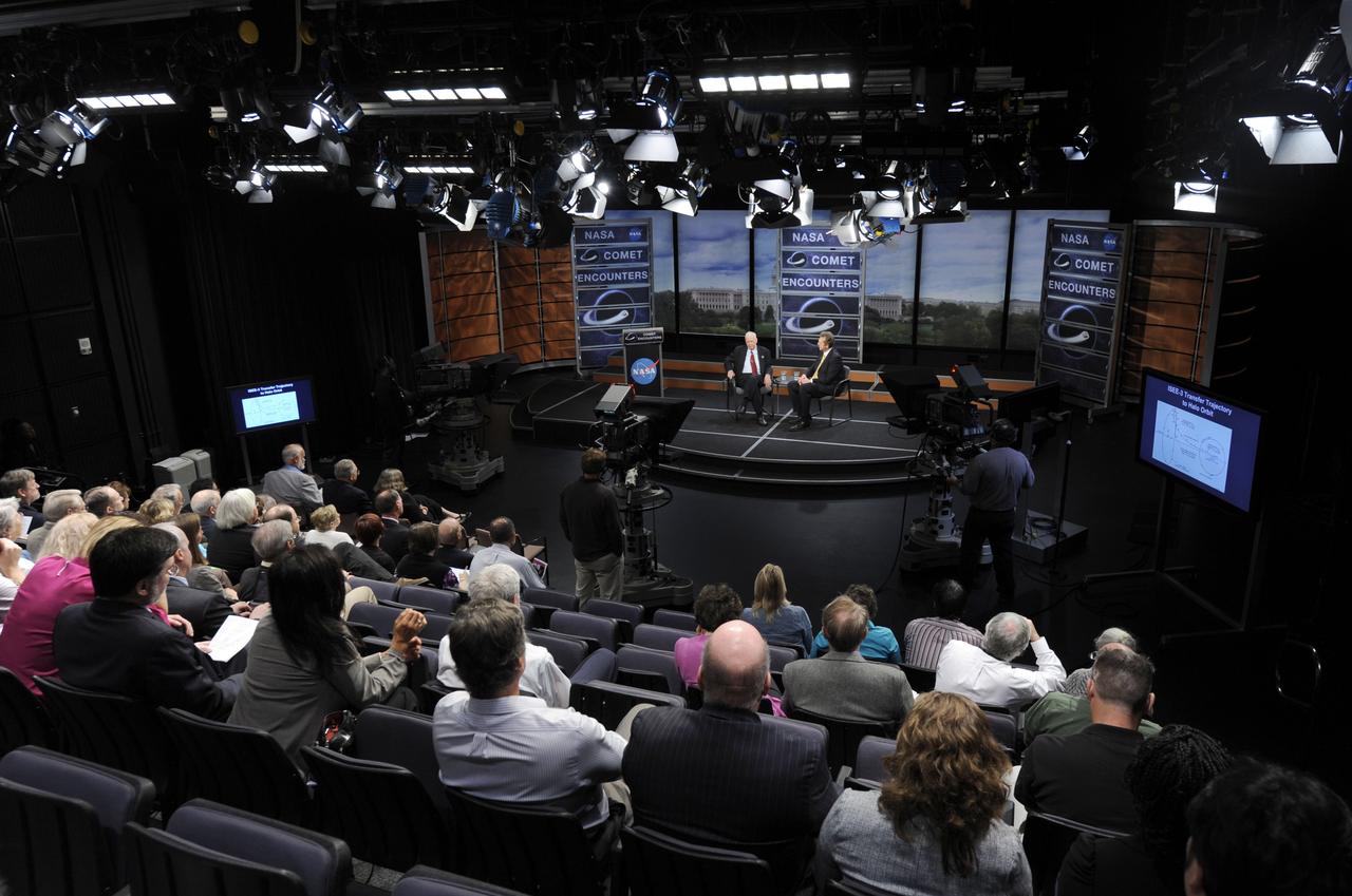 Members of the audience look on as Dr. James L. Green, Director of Planetary Science at NASA, right, speaks with Dr. Robert Farquar, an executive for space exploration at KinetX Inc., during a symposium commemorating a quarter-century of comet discoveries, Friday, Sept. 10, 2010, in the Knight studio at the Newseum in Washington. The International Sun-Earth Explorer-3 (ISEE-3) spacecraft flew past the comet Giacobini-Zinner on Sept. 11, 1985 which established a foundation of discoveries that continue today. Photo Credit: (NASA/Paul E. Alers)