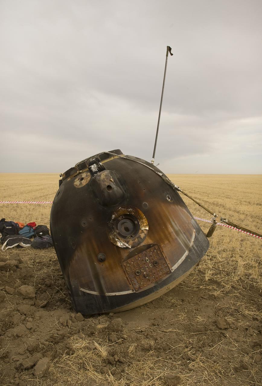 The Soyuz TMA-18 spacecraft, with it's crew of three still inside, is seen just moments after landing with Expedition 24 Commander Alexander Skvortsov and Flight Engineers Tracy Caldwell Dyson and Mikhail Kornienko near the town of Arkalyk, Kazakhstan on Saturday, Sept. 25, 2010. Russian Cosmonauts Skvortsov and Kornienko and NASA Astronaut Caldwell Dyson, are returning from six months onboard the International Space Station where they served as members of the Expedition 23 and 24 crews. Photo Credit: (NASA/Bill Ingalls)