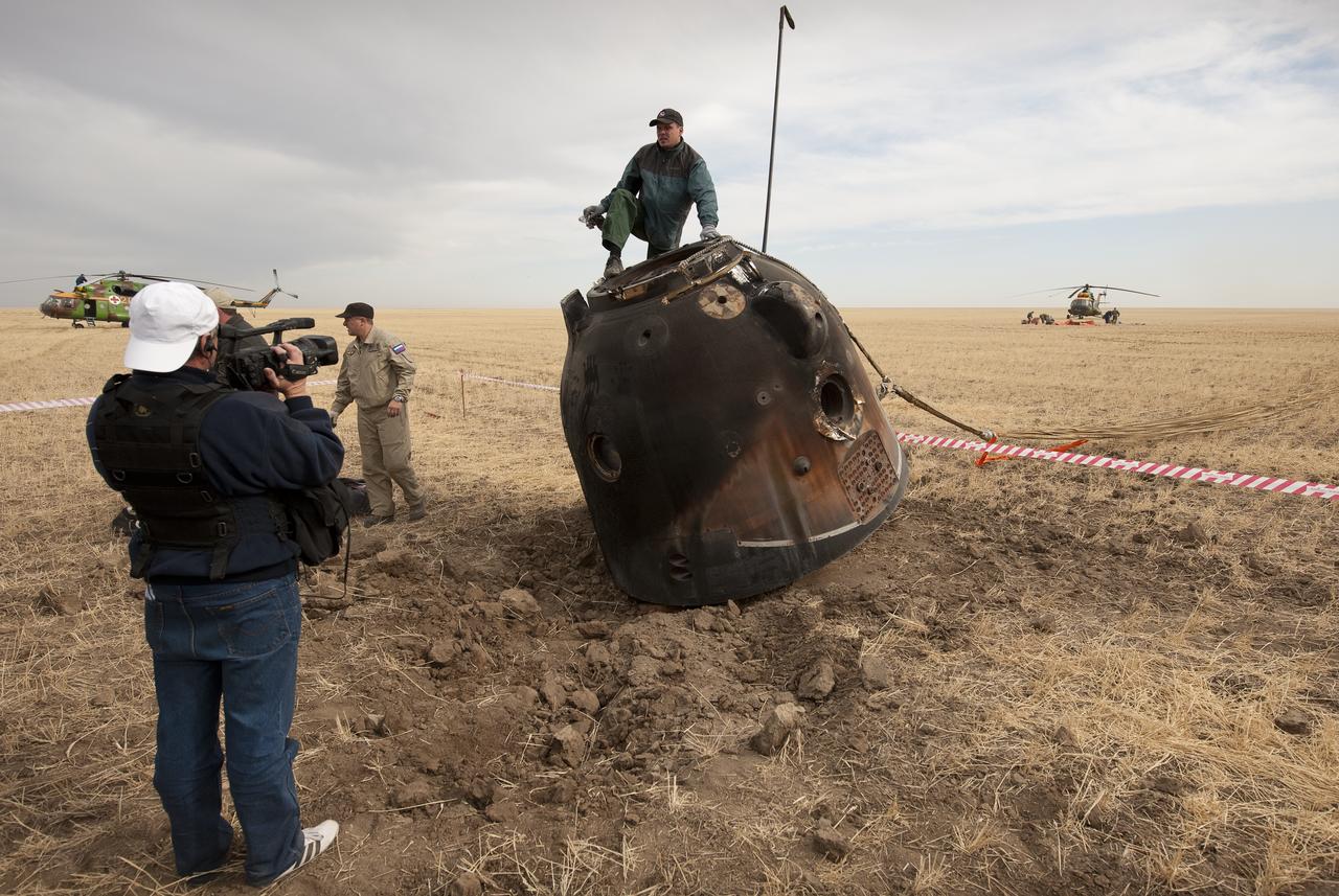 Russian search and rescue personnel and engineers prepare to extract the crew from the Soyuz TMA-18 moments after it landed with Expedition 24 Commander Alexander Skvortsov and Flight Engineers Tracy Caldwell Dyson and Mikhail Kornienko near the town of Arkalyk, Kazakhstan on Saturday, Sept. 25, 2010. Russian Cosmonauts Skvortsov and Kornienko and NASA Astronaut Caldwell Dyson, are returning from six months onboard the International Space Station where they served as members of the Expedition 23 and 24 crews. Photo Credit: (NASA/Bill Ingalls)