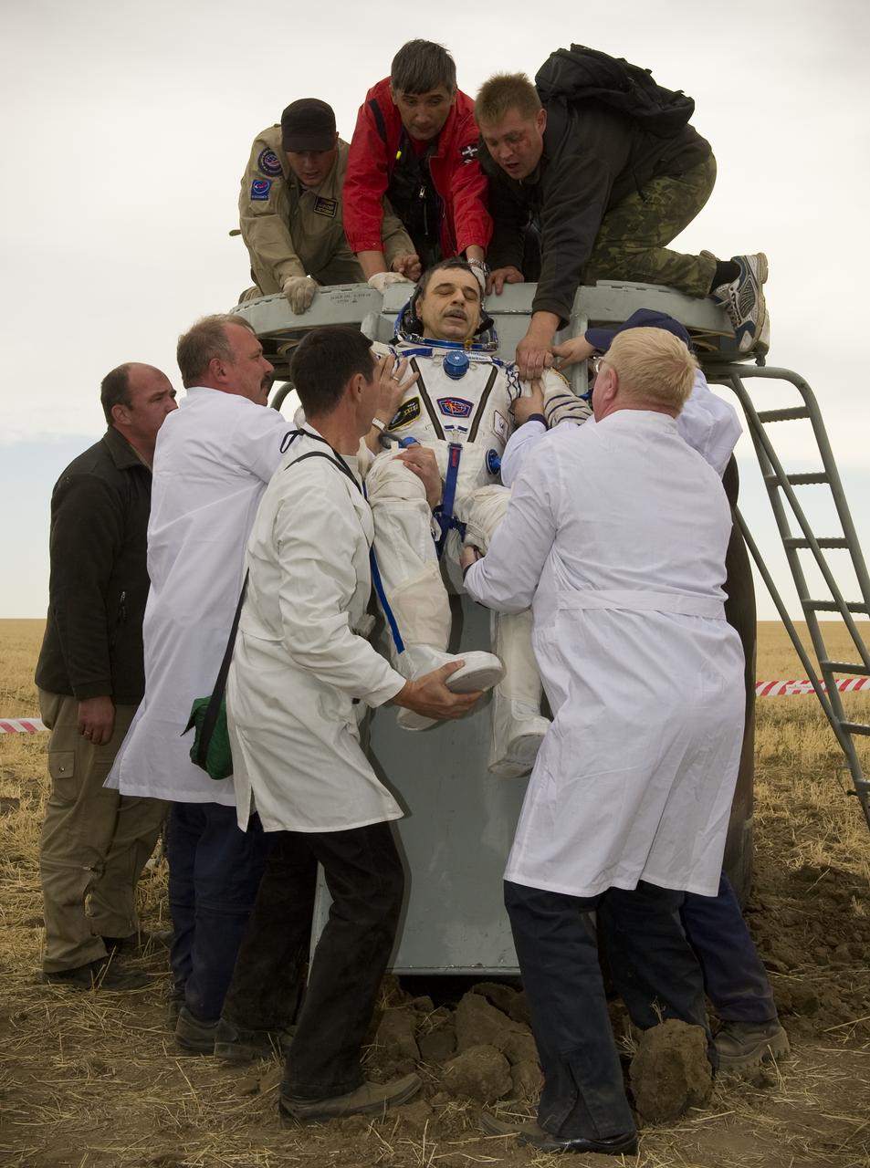Expedition 24 Flight Engineer Mikhail Kornienko is helped out of the Soyuz TMA-18 spacecraft shortly after landing with fellow crew members Commander Alexander Skvortsov and Tracy Caldwell Dyson near the town of Arkalyk, Kazakhstan on Saturday, Sept. 25, 2010. Russian Cosmonauts Skvortsov and Kornienko and NASA Astronaut Caldwell Dyson, are returning from six months onboard the International Space Station where they served as members of the Expedition 23 and 24 crews. Photo Credit: (NASA/Bill Ingalls)