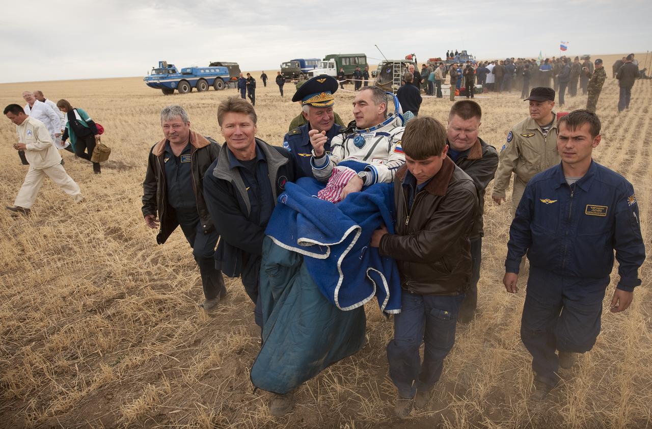 Expedition 24 Commander Alexander Skvortsov is carried to the medical tent shortly after landing in the Soyuz TMA-18 spacecraft with fellow crew members Tracy Caldwell Dyson and Mikhail Kornienko near the town of Arkalyk, Kazakhstan on Saturday, Sept. 25, 2010. Russian Cosmonauts Skvortsov and Kornienko and NASA Astronaut Caldwell Dyson, are returning from six months onboard the International Space Station where they served as members of the Expedition 23 and 24 crews. Photo Credit: (NASA/Bill Ingalls)