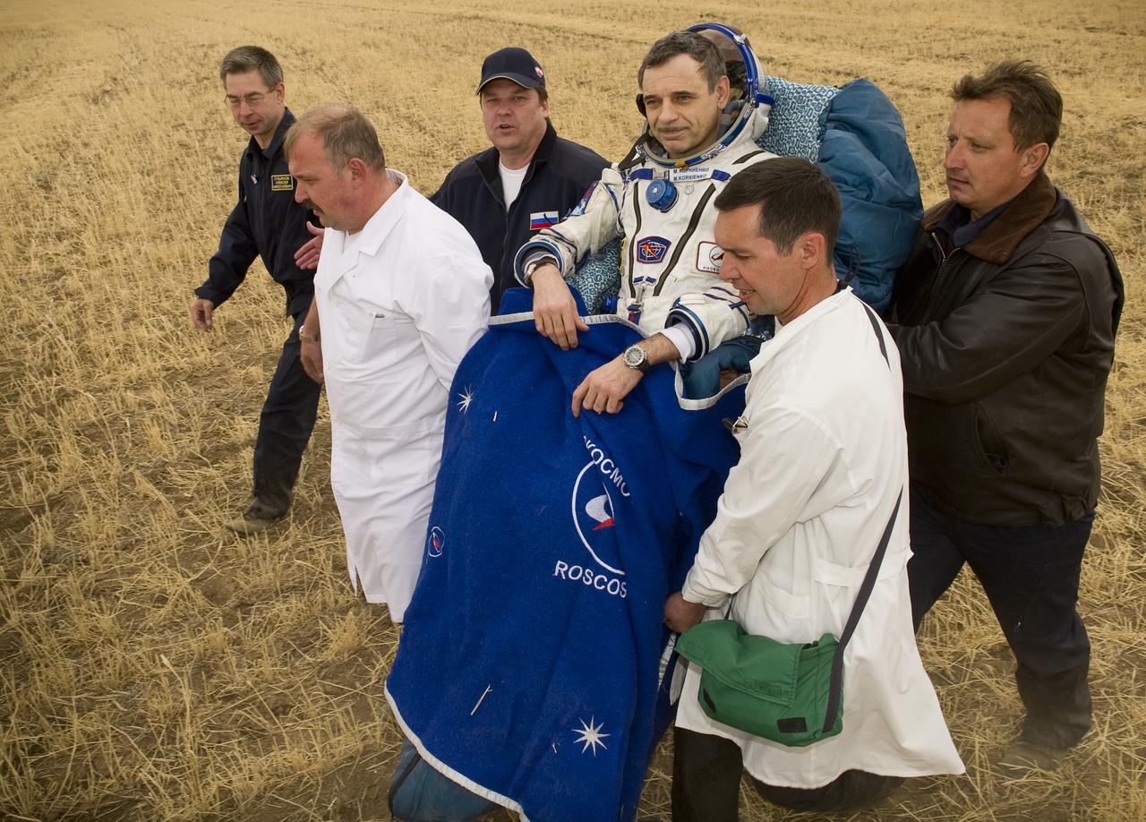 Expedition 24 Flight Engineer Mikhail Kornienko is carried to the medical tent shortly after landing in the Soyuz TMA-18 spacecraft with fellow crew members Commander Alexander Skvortsov and Tracy Caldwell Dyson near the town of Arkalyk, Kazakhstan on Saturday, Sept. 25, 2010. Russian Cosmonauts Skvortsov and Kornienko and NASA Astronaut Caldwell Dyson, are returning from six months onboard the International Space Station where they served as members of the Expedition 23 and 24 crews. Photo Credit: (NASA/Bill Ingalls)