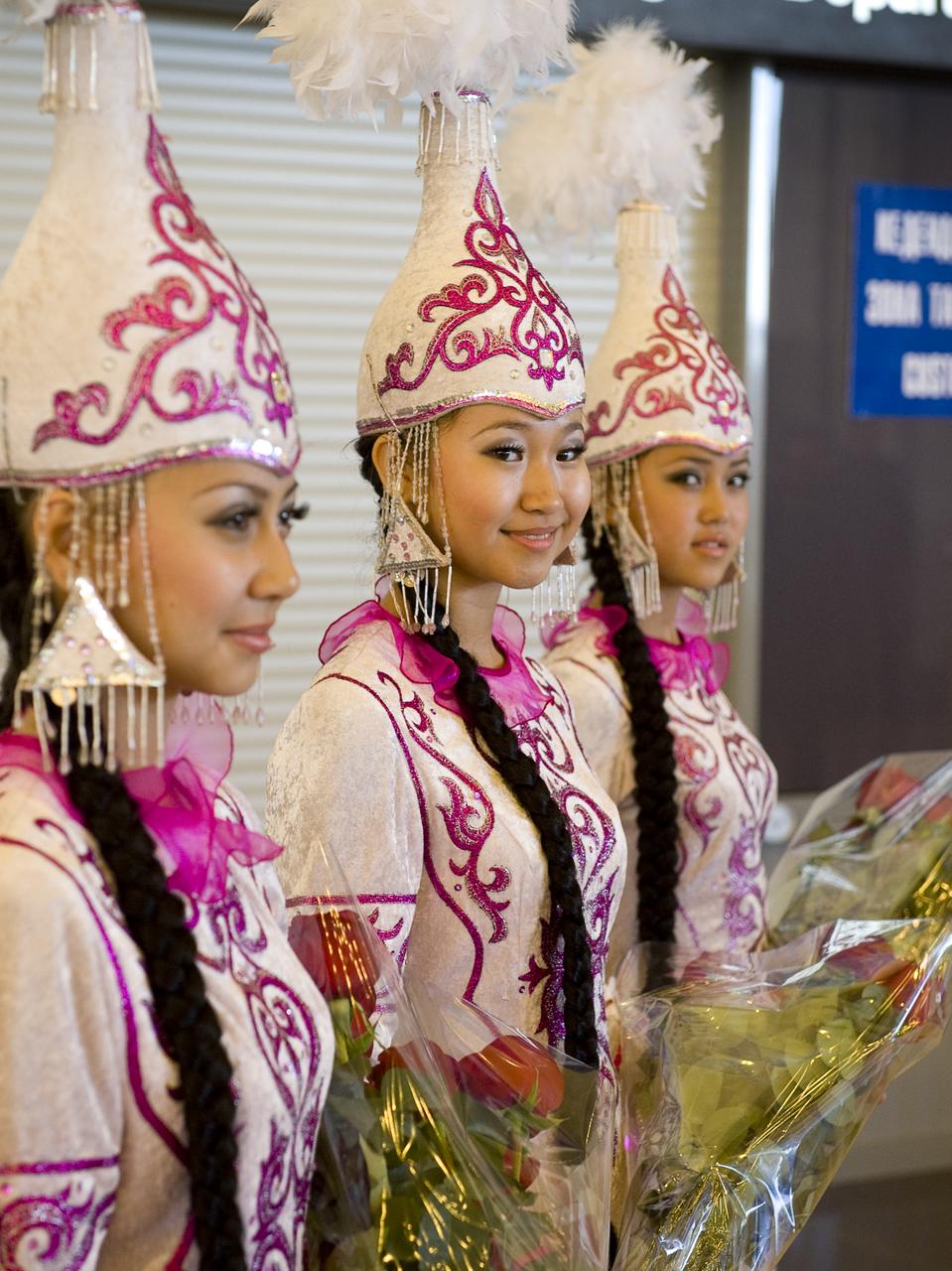 Girls in traditional Kazakhstan dress await the arrival of the Soyuz TMA-18 crew at the Karaganda airport in Kazakhstan. The Soyuz TMA-18 spacecraft, carrying Expedition 24 Commander Alexander Skvortsov and Flight Engineers Tracy Caldwell Dyson and Mikhail Kornienko, landed, near the town of Arkalyk, Kazakhstan on Saturday, Sept. 25, 2010.  Russian Cosmonauts Skvortsov and Kornienko and NASA Astronaut Caldwell Dyson, are returning from six months onboard the International Space Station where they served as members of the Expedition 23 and 24 crews. Photo Credit: (NASA/Bill Ingalls)