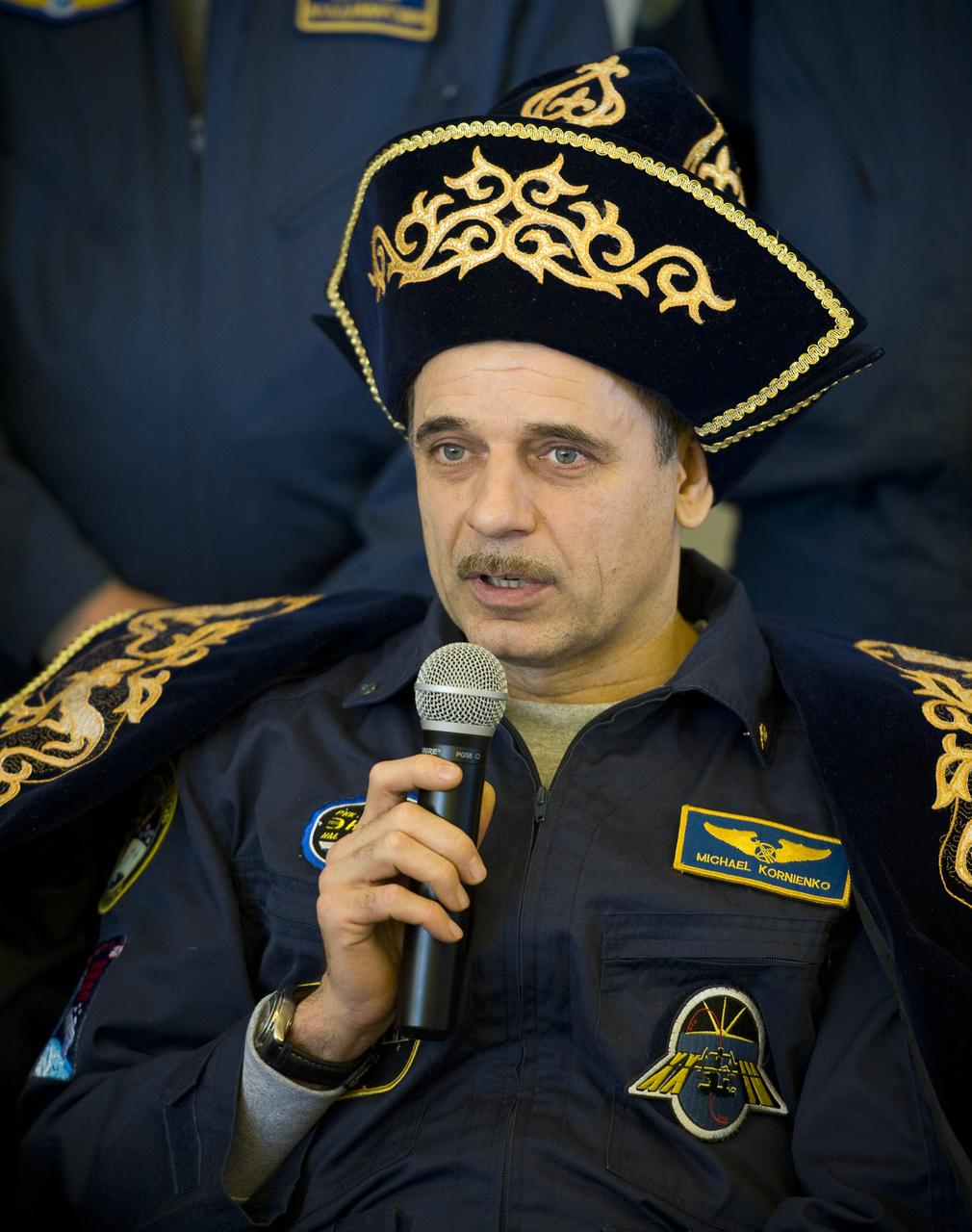 Expedition 24 Flight Engineer Mikhail Kornienko answer reporters questions in traditional Kazakh dress during a post flight ceremony and press conference at the Karaganda airport in Kazakhstan on Saturday, Sept. 25, 2010. The Soyuz TMA-18 spacecraft, carrying Expedition 24 Commander Alexander Skvortsov and Flight Engineers Tracy Caldwell Dyson and Kornienko, landed, near the town of Arkalyk, Kazakhstan on Saturday, Sept. 25, 2010.  Russian Cosmonauts Skvortsov and Kornienko and NASA Astronaut Caldwell Dyson, are returning from six months onboard the International Space Station where they served as members of the Expedition 23 and 24 crews. Photo Credit: (NASA/Bill Ingalls)