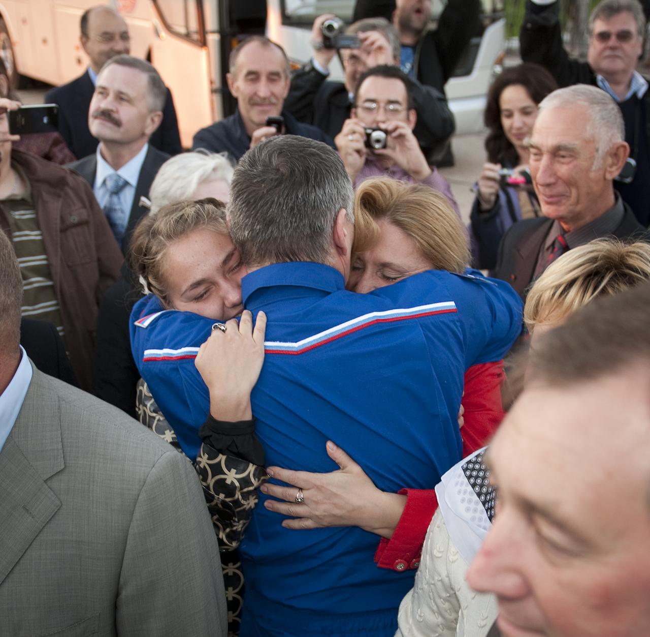 Expedition 24 Commander Alexander Skvortsov, embraces his family after he and Expedition 24 Flight Engineer Mikhail Kornienko arrived at Chkalovskaya airport just outside Moscow on Saturday, Sept. 25, 2010. Skvortsov, Kornienko and Expedition 24 Flight Engineer Tracy Caldwell Dyson, landed in their Soyuz TMA-18 spacecraft near the town of Arkalyk, Kazakhstan on Saturday, Sept. 25, 2010. Russian Cosmonauts Skvortsov and Kornienko and NASA Astronaut Caldwell Dyson, are returning from six months onboard the International Space Station where they served as members of the Expedition 23 and 24 crews. Photo Credit: (NASA/Bill Ingalls)