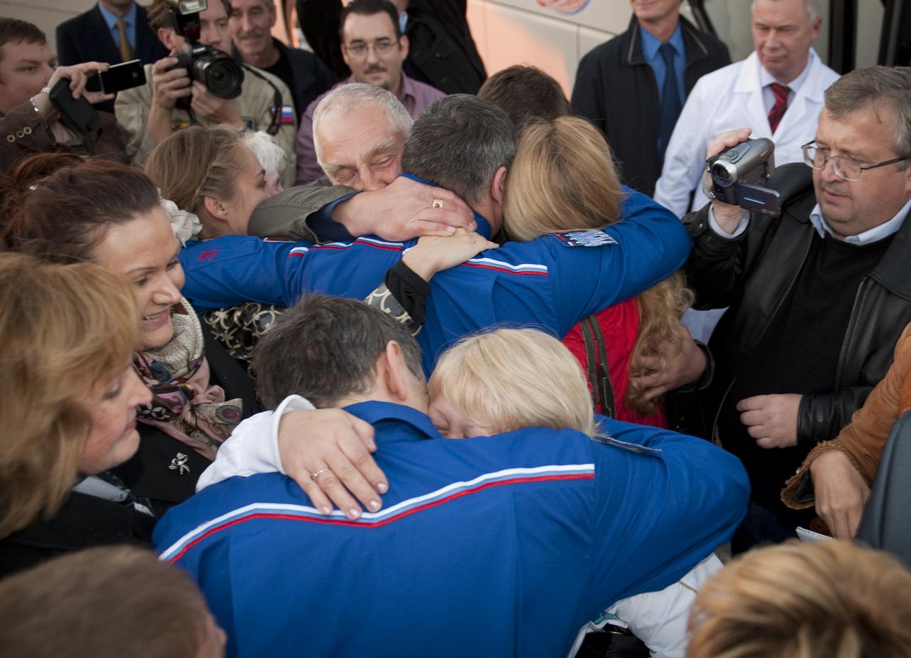 Expedition 24 Flight Engineer Mikhail Kornienko, foreground, and Expedition 24 Commander Alexander Skvortsov embrace their family and friends after their arrival at Chkalovskaya airport just outside Moscow on Saturday, Sept. 25, 2010. Skvortsov, Kornienko and Expedition 24 Flight Engineer Tracy Caldwell Dyson, landed in their Soyuz TMA-18 spacecraft near the town of Arkalyk, Kazakhstan on Saturday, Sept. 25, 2010. Russian Cosmonauts Skvortsov and Kornienko and NASA Astronaut Caldwell Dyson, are returning from six months onboard the International Space Station where they served as members of the Expedition 23 and 24 crews. Photo Credit: (NASA/Bill Ingalls)