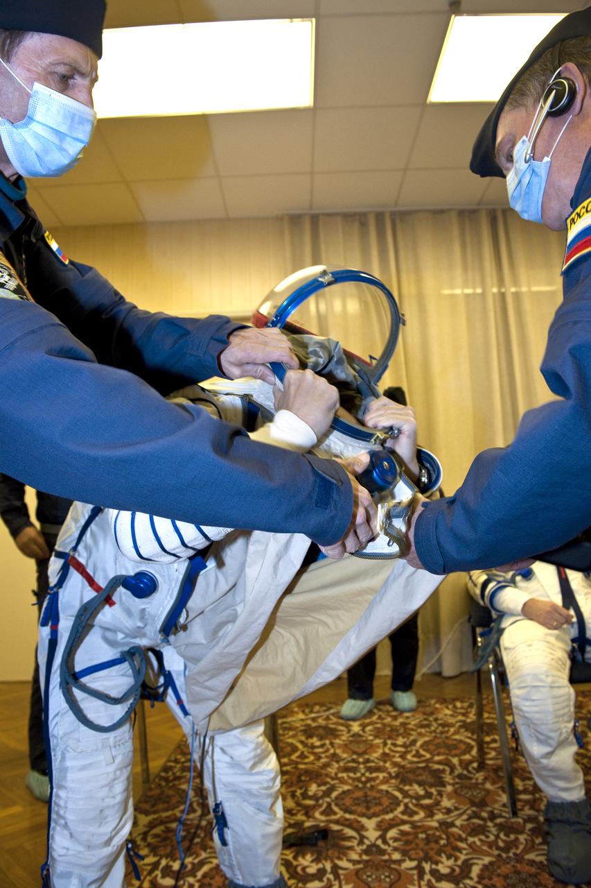Expedition 25 NASA Flight Engineer Scott Kelly of the U.S. has his Russian Sokol suit prepared for launch by a technician at the Baikonur Cosmodrome in Kazakhstan, Friday, Oct. 8, 2010.  Kelly and fellow Expedition 25 crew members Soyuz Commander Alexander Kaleri and Flight Engineer Oleg Skripochka launched in their Soyuz TMA-01M at 5:10 a.m. Friday morning. (Photo Credit: NASA/Carla Cioffi)