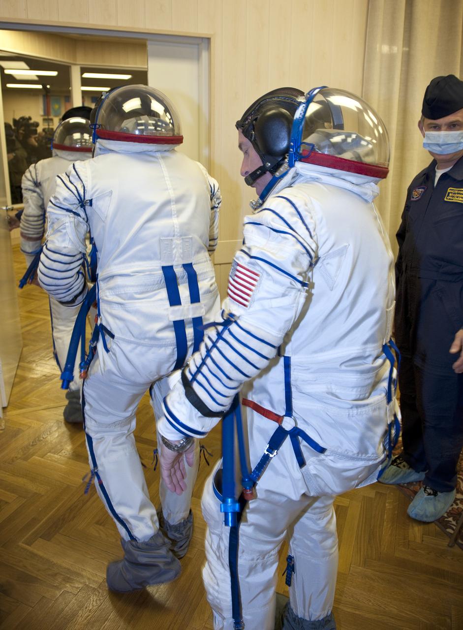 Expedition 25 crew members prepare to have their Russian Sokol Suits pressure checked at the Baikonur Cosmodrome in Kazakhstan on Friday, Oct. 8, 2010. Soyuz Commander Alexander Kaleri, NASA Flight Engineer Scott Kelly and Flight Engineer Oleg Skripochka launched in their Soyuz TMA-01M at 5:10 a.m. Friday morning. (Photo Credit: NASA/Carla Cioffi)