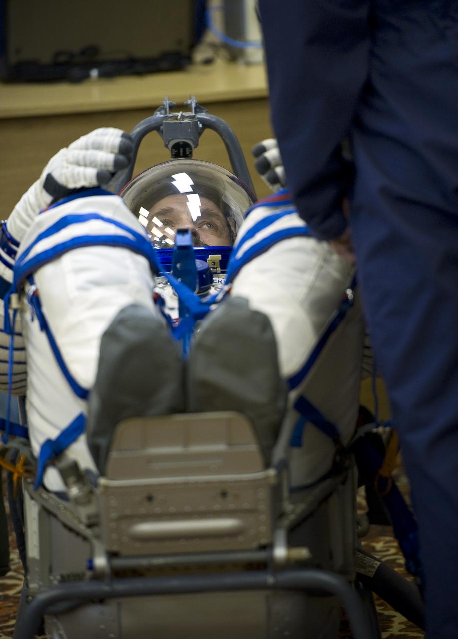 Expedition 25 Soyuz Commander Alexander Kaleri has his Russian Sokol Suit pressure checked at the Baikonur Cosmodrome in Kazakhstan on Friday, Oct. 8, 2010. (Photo Credit: NASA/Carla Cioffi)