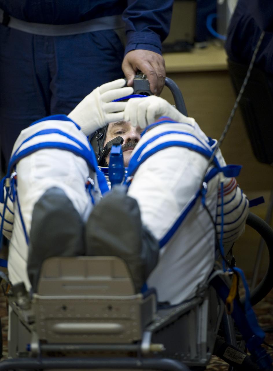 Expedition 25 Soyuz Commander Alexander Kaleri has his Russian Sokol Suit pressure checked at the Baikonur Cosmodrome in Kazakhstan on Friday, Oct. 8, 2010. (Photo Credit: NASA/Carla Cioffi)