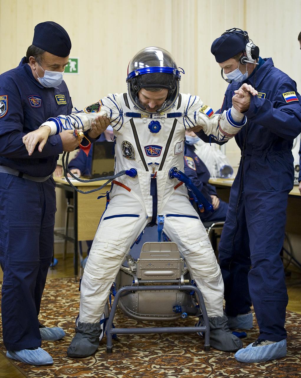 Expedition 25 Soyuz Commander Alexander Kaleri has his Russian Sokol Suit pressure checked at the Baikonur Cosmodrome in Kazakhstan on Friday, Oct. 8, 2010. (Photo Credit: NASA/Carla Cioffi)