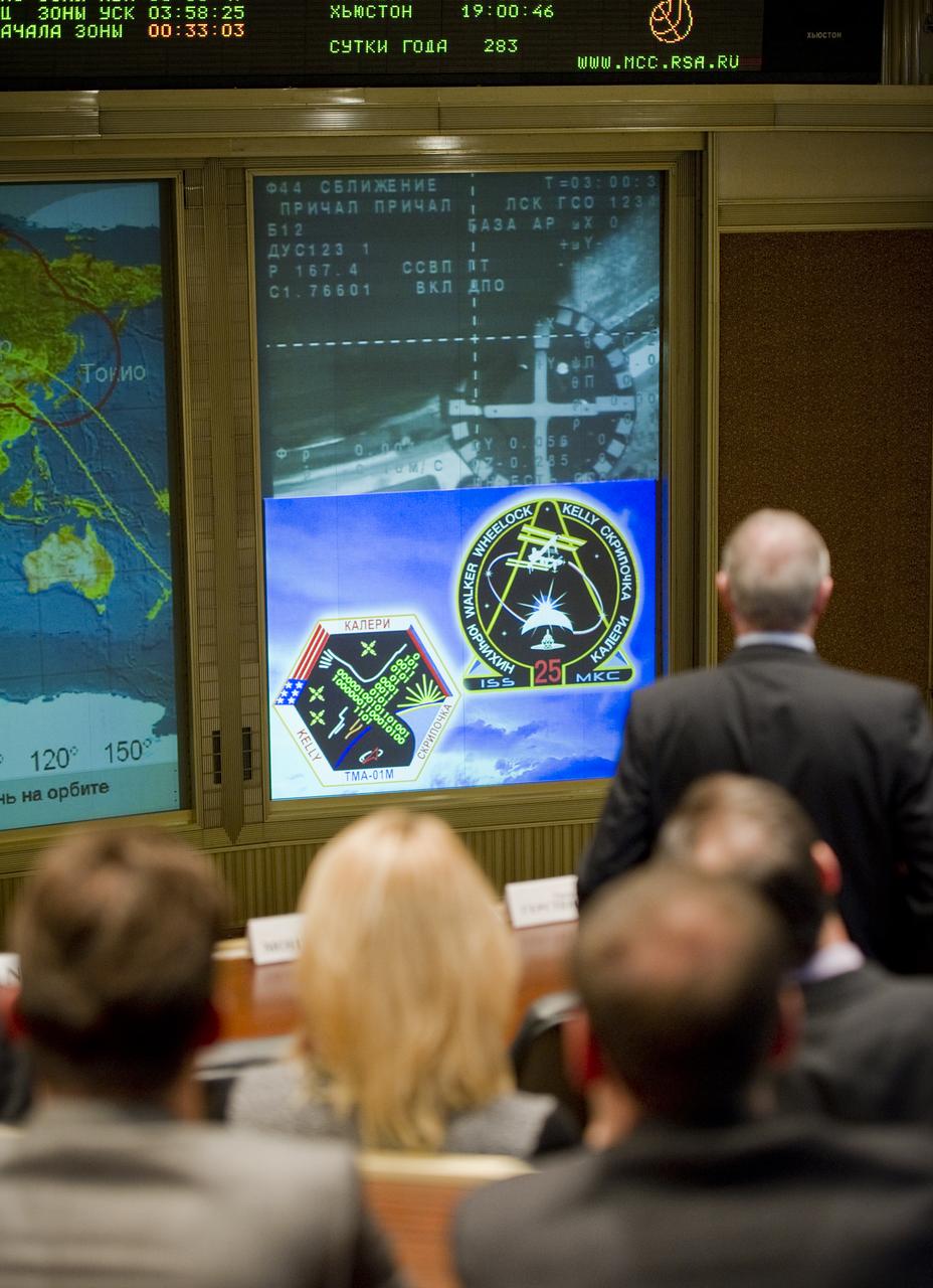 The Soyuz TMA-01M nears its docking with the International Space Station as seen in the video monitor at Russian Mission Control Center in Korolev, Russia on Sunday, Oct. 10, 2010.  The TMA-01M delivered the crew of Expedition 25 Soyuz Commander Alexander Kaleri, Flight Engineer Scott Kelly and Flight Engineer Oleg Skripochka to the ISS.  Photo Credit: (NASA/Carla Cioffi)