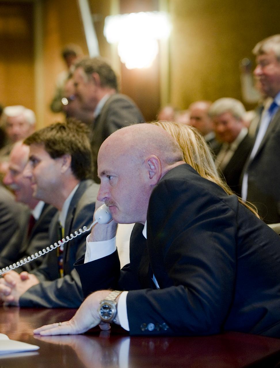 NASA astronaut Mark Kelly speaks on the phone to his twin brother, Expedition 25 Flight Engineer Scott Kelly, after his arrival to the International Space Station on Sunday, Oct. 10, 2010 in Korolev, Russia.  Photo Credit: (NASA/Carla Cioffi)
