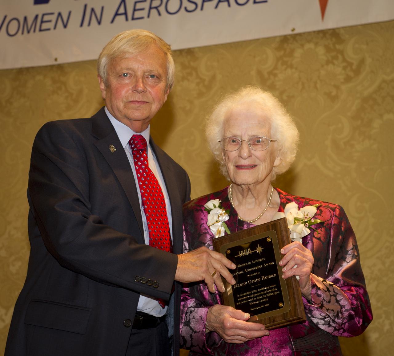 NASA's Associate Administrator of the Science Mission Directorate Dr. Edward J. Weiler presents the Women in Aerospace's Lifetime Achievement Award to retired NASA chief astronomer Nancy Grace Roman at the organization's annual awards ceremony and banquet held at the Ritz-Carlton Hotel in Arlington, VA on Tuesday, Oct. 26, 2010.  Four current NASA leaders and one retiree were recognized for their work by Women in Aerospace. The event celebrates women's professional excellence in aerospace and honors women who have made outstanding contributions to the aerospace community. Photo Credit: (NASA/Bill Ingalls)
