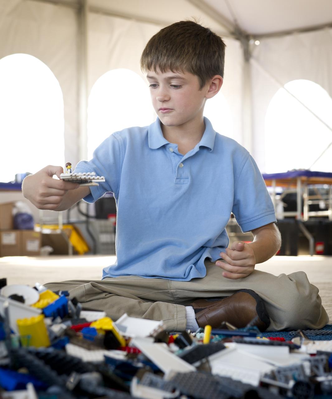 NASA Officials, LEGO Group management, students, teachers and parents create their vision of the future in space with LEGO bricks and elements as part of a “Build the Future” activity inside a tent that was set up on the launch viewing area at NASA's Kennedy Space Center in Cape Canaveral, Fla. on Monday, Nov. 1, 2010.  NASA and The LEGO Group signed a Space Act Agreement to spark children's interest in science, technology, engineering and math (STEM). Photo Credit: (NASA/Bill Ingalls)