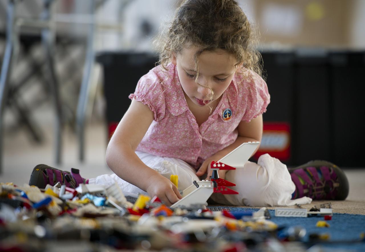 NASA Officials, LEGO Group management, students, teachers and parents create their vision of the future in space with LEGO bricks and elements as part of a “Build the Future” activity inside a tent that was set up on the launch viewing area at NASA's Kennedy Space Center in Cape Canaveral, Fla. on Monday, Nov. 1, 2010.  NASA and The LEGO Group signed a Space Act Agreement to spark children's interest in science, technology, engineering and math (STEM). Photo Credit: (NASA/Bill Ingalls)