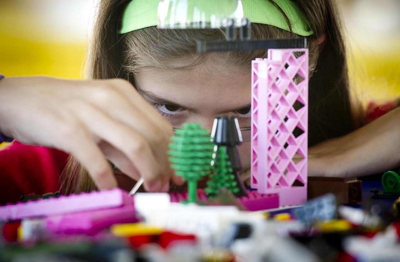 NASA Officials, LEGO Group management, students, teachers and parents create their vision of the future in space with LEGO bricks and elements as part of a “Build the Future” activity inside a tent that was set up on the launch viewing area at NASA's Kennedy Space Center in Cape Canaveral, Fla. on Monday, Nov. 1, 2010.  NASA and The LEGO Group signed a Space Act Agreement to spark children's interest in science, technology, engineering and math (STEM). Photo Credit: (NASA/Bill Ingalls)