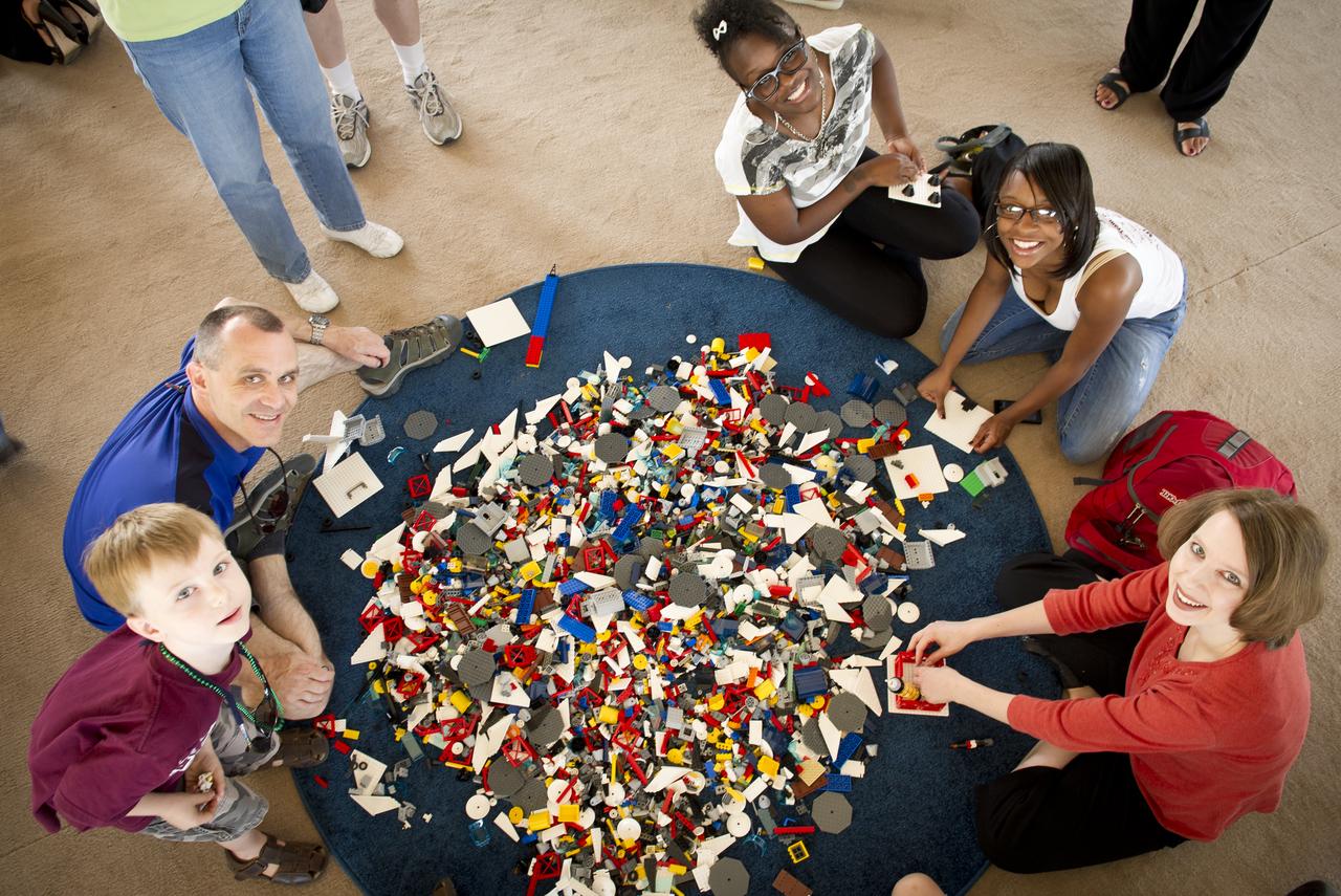 NASA Officials, LEGO Group management, students, teachers and parents create their vision of the future in space with LEGO bricks and elements as part of a “Build the Future” activity inside a tent that was set up on the launch viewing area at NASA's Kennedy Space Center in Cape Canaveral, Fla. on Monday, Nov. 1, 2010.  NASA and The LEGO Group signed a Space Act Agreement to spark children's interest in science, technology, engineering and math (STEM). Photo Credit: (NASA/Bill Ingalls)