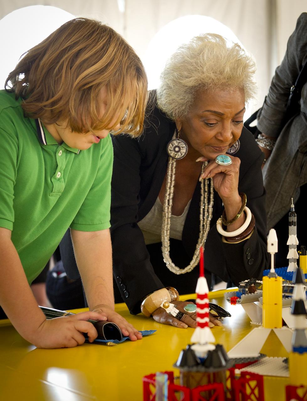 Actress Nichelle Nichols, known for her most famous role as communications officer Lieutenant Uhura aboard the USS Enterprise in the popular Star Trek television series, talks with school children during the “Build the Future” activity where students created their vision of the future in space with LEGO bricks and elements inside a tent that was set up on the launch viewing area at NASA's Kennedy Space Center in Cape Canaveral, Fla. on Monday, Nov. 1, 2010.  NASA and The LEGO Group signed a Space Act Agreement to spark children's interest in science, technology, engineering and math (STEM). Photo Credit: (NASA/Bill Ingalls)