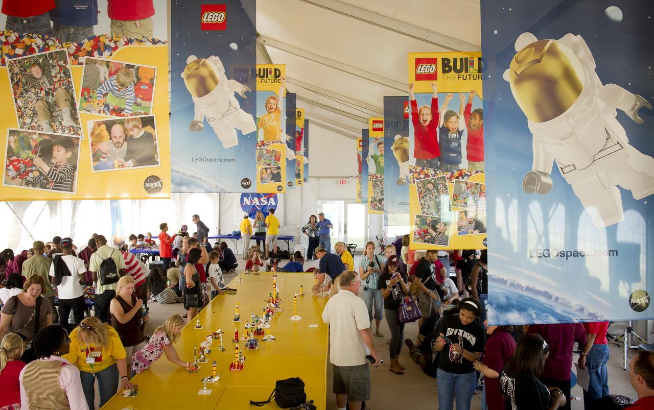 NASA Officials, LEGO Group management, students, teachers and parents create their vision of the future in space with LEGO bricks and elements as part of a “Build the Future” activity inside a tent that was set up on the launch viewing area at NASA's Kennedy Space Center in Cape Canaveral, Fla. on Monday, Nov. 1, 2010.  NASA and The LEGO Group signed a Space Act Agreement to spark children's interest in science, technology, engineering and math (STEM). Photo Credit: (NASA/Bill Ingalls)