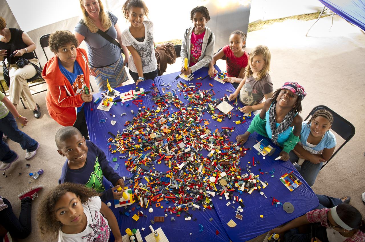 NASA Officials, LEGO Group management, students, teachers and parents create their vision of the future in space with LEGO bricks and elements as part of a “Build the Future” activity inside a tent that was set up on the launch viewing area at NASA's Kennedy Space Center in Cape Canaveral, Fla. on Monday, Nov. 1, 2010.  NASA and The LEGO Group signed a Space Act Agreement to spark children's interest in science, technology, engineering and math (STEM). Photo Credit: (NASA/Bill Ingalls)