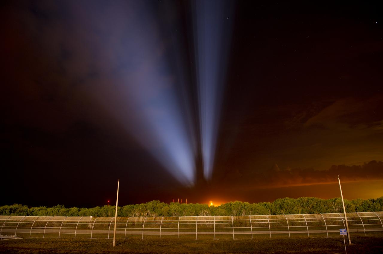 An faint profile outline of the space shuttle Discovery and launch pad 39a are seen projected in the sky as powerful xenon lights illuminate launch pad 39a on Wednesday, Nov. 3, 2010 at the NASA Kennedy Space Center in Cape Canaveral, Fla.  During space shuttle Discovery's final spaceflight, the STS-133 crew members will take important spare parts to the International Space Station along with the Express Logistics Carrier-4. Photo Credit: (NASA/Bill Ingalls)