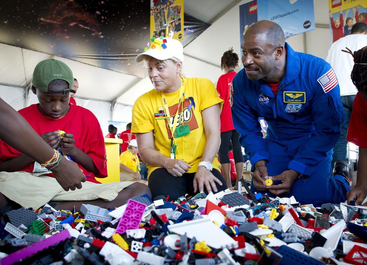 Associate Administrator for Education and Astronaut Leland Melvin talks with school children during the “Build the Future” activity where students created their vision of the future in space with LEGO bricks and elements inside a tent that was set up on the launch viewing area at NASA's Kennedy Space Center in Cape Canaveral, Fla. on Monday, Nov. 1, 2010.  NASA and The LEGO Group signed a Space Act Agreement to spark children's interest in science, technology, engineering and math (STEM). Photo Credit: (NASA/Bill Ingalls)