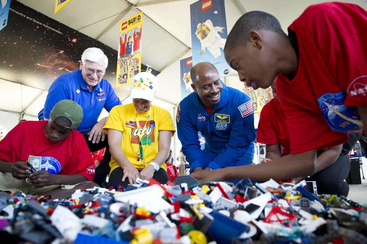 President of LEGO Education USA Stephan Turnipseed, back left, and Associate Administrator for Education and Astronaut Leland Melvin, 2nd from right, talk with a student during the “Build the Future” activity where students created their vision of the future in space with LEGO bricks and elements inside a tent that was set up on the launch viewing area at NASA's Kennedy Space Center in Cape Canaveral, Fla. on Monday, Nov. 1, 2010.  NASA and The LEGO Group signed a Space Act Agreement to spark children's interest in science, technology, engineering and math (STEM). Photo Credit: (NASA/Bill Ingalls)