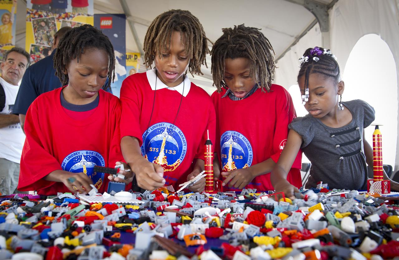 NASA Officials, LEGO Group management, students, teachers and parents create their vision of the future in space with LEGO bricks and elements as part of a “Build the Future” activity inside a tent that was set up on the launch viewing area at NASA's Kennedy Space Center in Cape Canaveral, Fla. on Wednesday, Nov. 3, 2010.  NASA and The LEGO Group signed a Space Act Agreement to spark children's interest in science, technology, engineering and math (STEM). Photo Credit: (NASA/Bill Ingalls)
