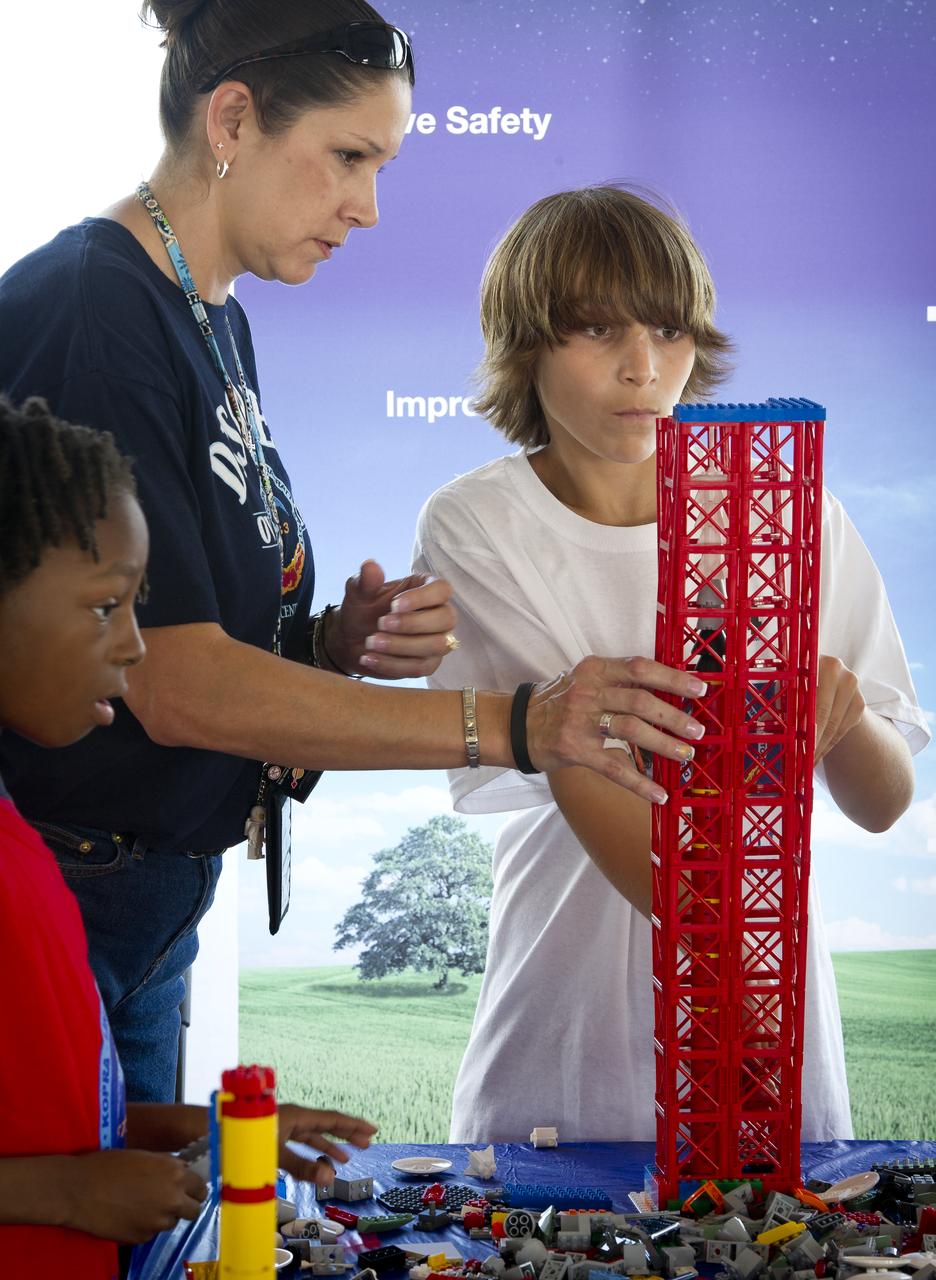 NASA Officials, LEGO Group management, students, teachers and parents create their vision of the future in space with LEGO bricks and elements as part of a “Build the Future” activity inside a tent that was set up on the launch viewing area at NASA's Kennedy Space Center in Cape Canaveral, Fla. on Wednesday, Nov. 3, 2010.  NASA and The LEGO Group signed a Space Act Agreement to spark children's interest in science, technology, engineering and math (STEM). Photo Credit: (NASA/Bill Ingalls)