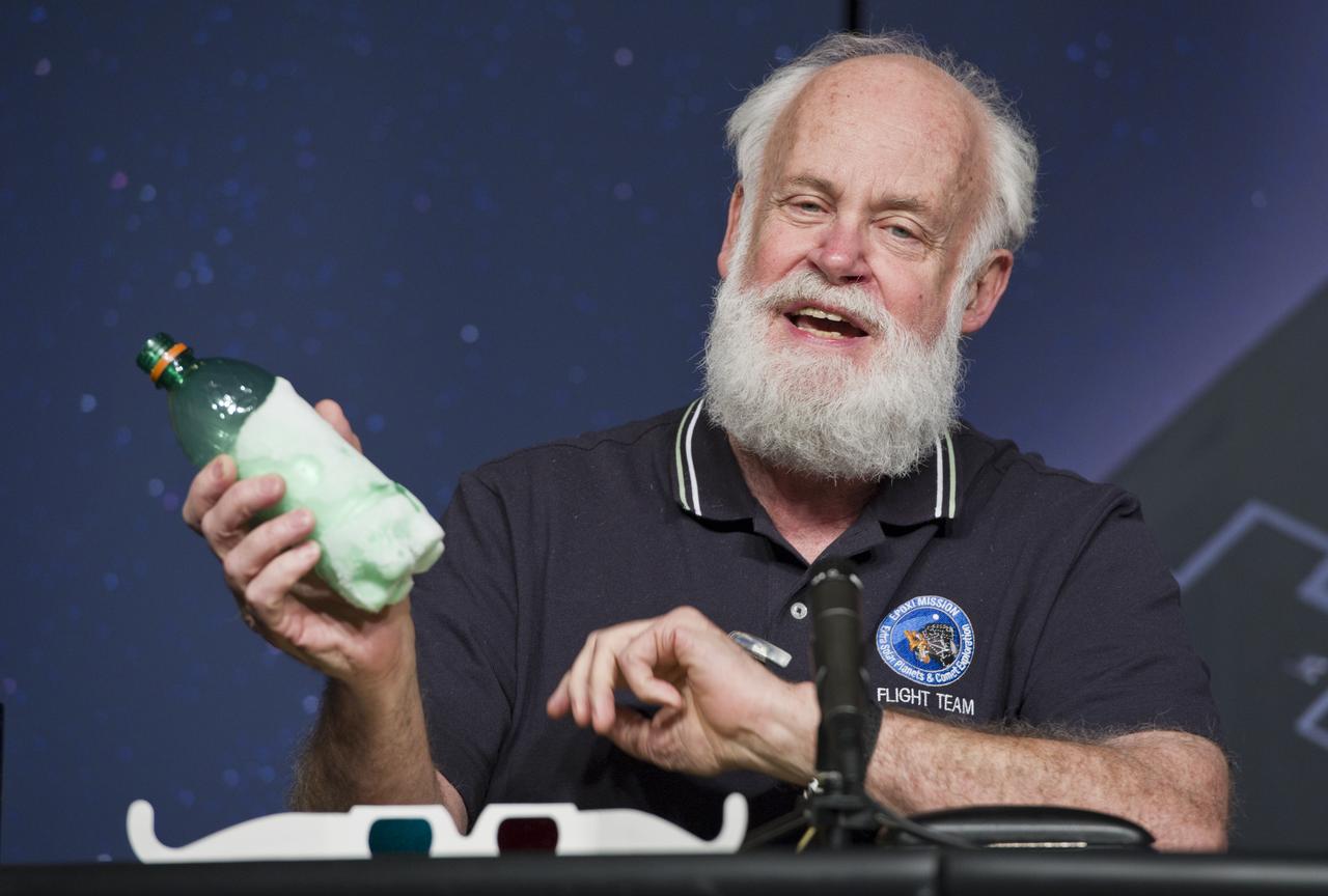 Michael A'Hearn, EPOXI Principal Investigator, University of Maryland, holds a plastic bottle containing ice to illustrate a point during a press conference, Thursday, Nov. 18, 2010, at NASA Headquarters in Washington. The press conference was held to discuss the Nov. 4 successful flyby of Comet Hartley 2 by NASA's EPOXI Mission Spacecraft. Images from the flyby provided scientists the most extensive observations of a comet in history. Photo Credit: (NASA/Paul E. Alers)