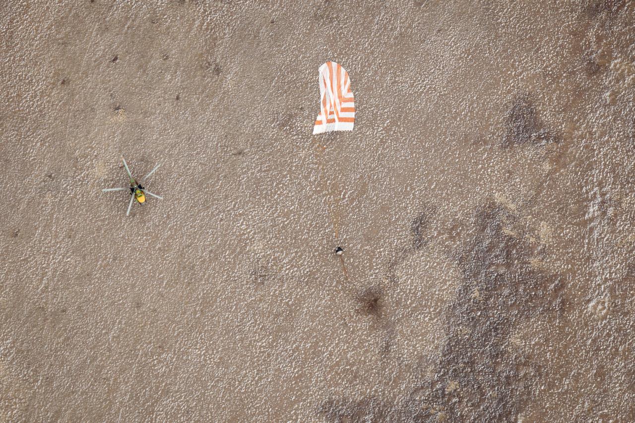 A Russian Search and Rescue helicopter lands near the Soyuz TMA-19 spacecraft shortly after touch down with Expedition 25 Commander Doug Wheelock and Flight Engineers Shannon Walker and Fyodor Yurchikhin near the town of Arkalyk, Kazakhstan on Friday, Nov. 26, 2010. Russian Cosmonaut Yurchikhin and NASA Astronauts Wheelock and Walker, are returning from nearly six months onboard the International Space Station where they served as members of the Expedition 24 and 25 crews. Photo Credit: (NASA/Bill Ingalls)