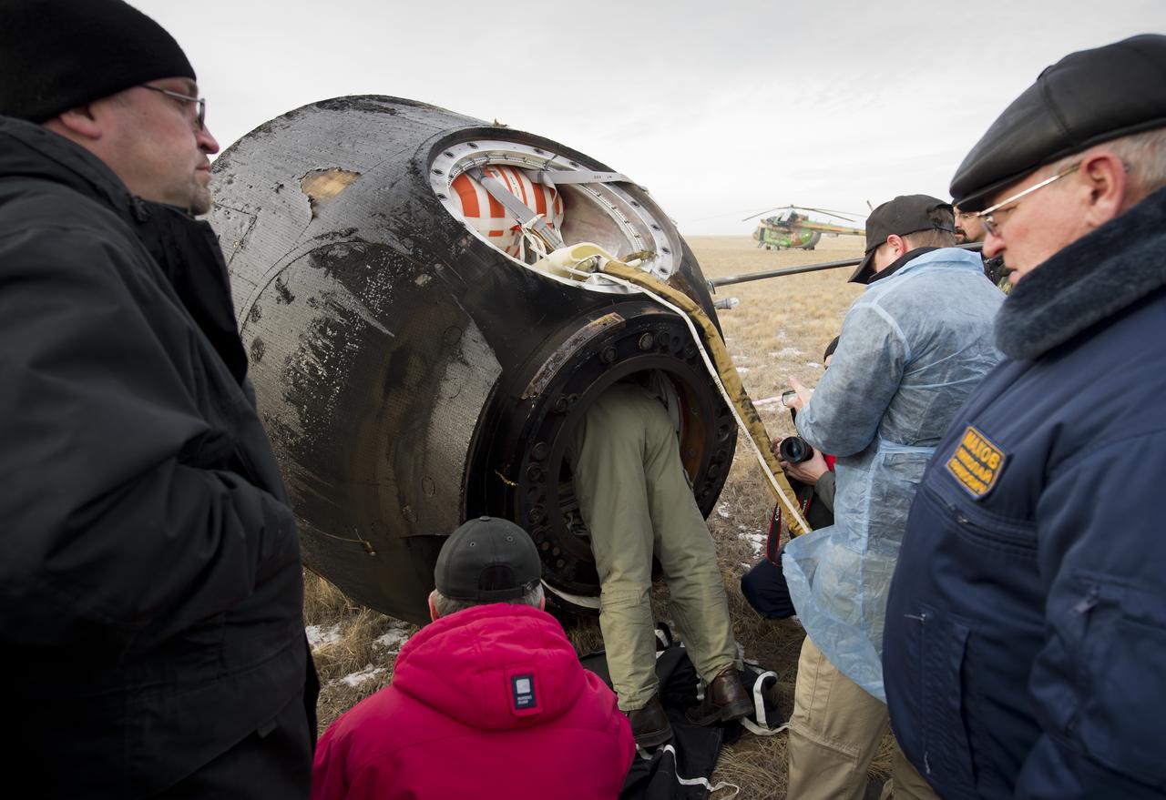 A technician enters the Soyuz TMA-19 spacecraft with Expedition 25 Commander Doug Wheelock and Flight Engineers Shannon Walker and Fyodor Yurchikhin in order to assist with getting the crew out of the capsule, near Arkalyk, Kazakhstan on Friday, Nov. 26, 2010. Russian Cosmonaut Yurchikhin and NASA Astronauts Wheelock and Walker, are returning from nearly six months onboard the International Space Station where they served as members of the Expedition 24 and 25 crews. Photo Credit: (NASA/Bill Ingalls)