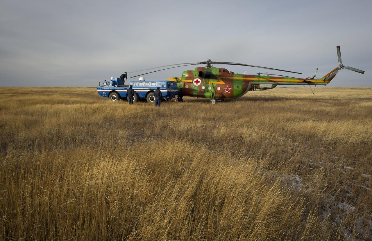 A Russian Search and Rescue all terrain vehicle carrying Expedition 25 Flight Engineer Shannon Walker from the medical tent pulls up to a helicopter shortly after Walker, Expedition 25 Commander Doug Wheelock and Flight Engineer Fyodor Yurchikhin landed in the Soyuz TMA-19 spacecraft near Arkalyk, Kazakhstan on Friday, Nov. 26, 2010.  Russian Cosmonaut Yurchikhin and NASA Astronauts Wheelock and Walker, are returning from nearly six months onboard the International Space Station where they served as members of the Expedition 24 and 25 crews. Photo Credit: (NASA/Bill Ingalls)